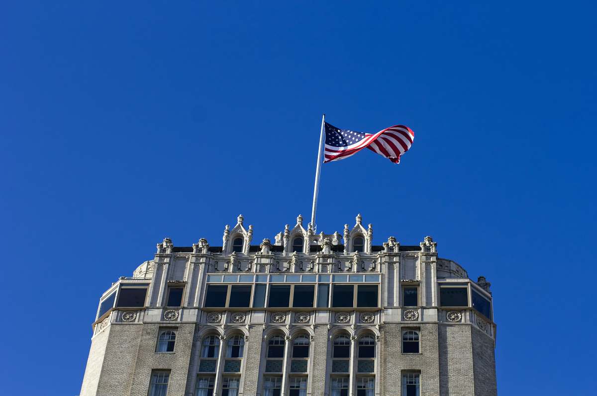 flag USA flag on pole on top of building symbol